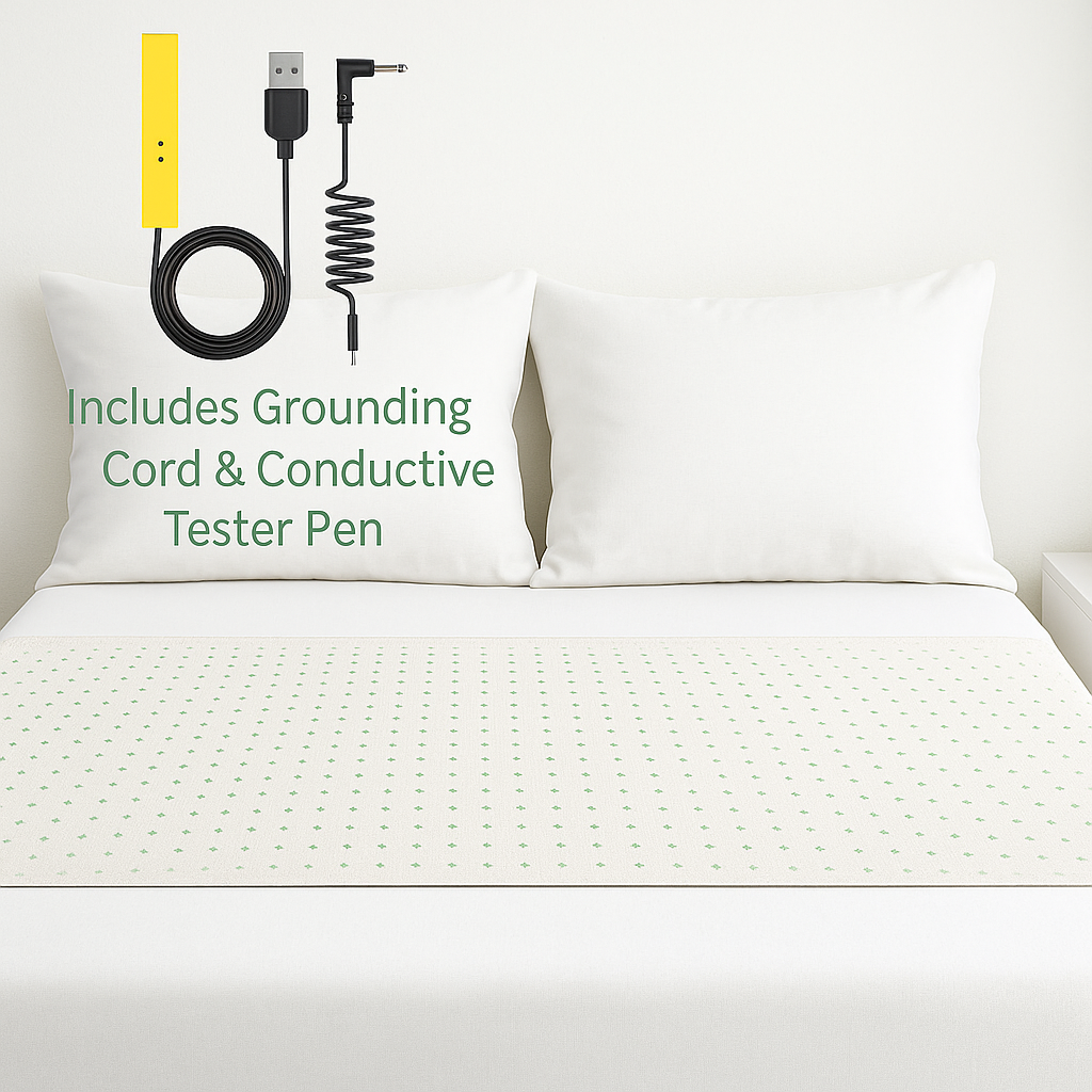 Bed with white mattress and pillows, featuring a grounding cord and conductive tester pen on top.